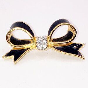 Black enamel and gold tone bow brooch pin with rhinestones in center
